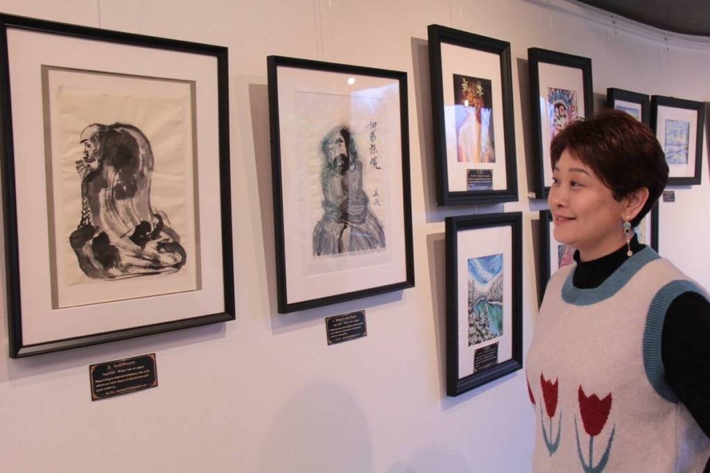 Sia Xia showcases her transition from ink to colour on the walls of Saanich municipal hall. (Christine van Reeuwyk/Saanich News)