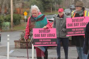 Shirley Hunter, of Action Oak Bay which organized the event, crosses Oak Bay Avenue during the group walk to call for movement on the long-vacant Oak Bay Lodge site. (Christine van Reeuwyk/Oak Bay News file photo)